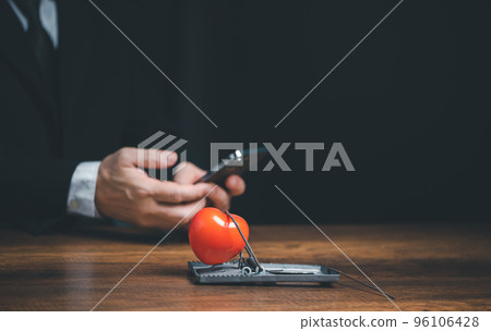 Online internet romance scam or swindler in website application dating concept, Love is bait or victim, Red heart in a rat trap, Young business people using mobile phone searching love dating girl 96106428