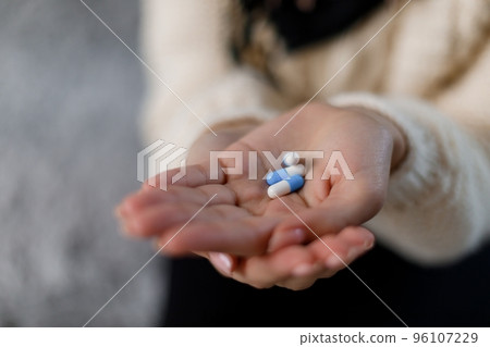 Pills in female hand Pills in female hand 96107229