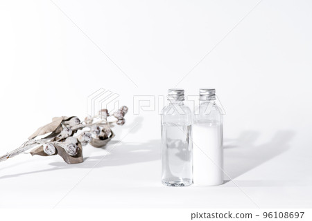Plastic cosmetic bottles with lotion and emulsion and dried flowers 96108697