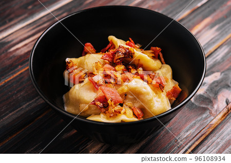 Baked potato dumplings with fried bacon and onions Baked potato dumplings with fried bacon and onions 96108934
