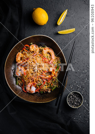 Stir fry noodles with vegetables and shrimps in black bowl Stir fry noodles with vegetables and shrimps in black bowl 96108943