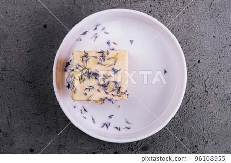 French mille feuille cake with vanilla cream decorated with blue flower leaves French mille feuille cake with vanilla cream decorated with blue flower leaves 96108955