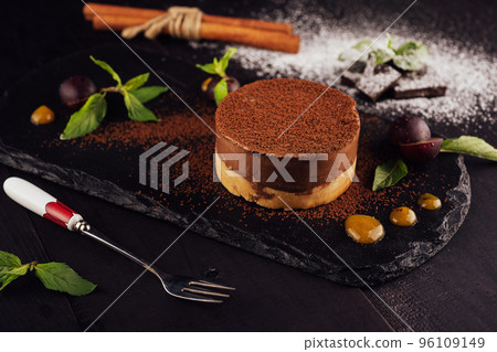 Mango and chocolate mousse on wooden black Mango and chocolate mousse on wooden black 96109149