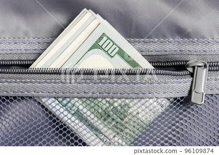 Cash stash. Stack of cash. A pack of hundred dollar bills in a transparent pocket. Cash stash. Stack of cash. A pack of hundred dollar bills in a transparent pocket. 96109874