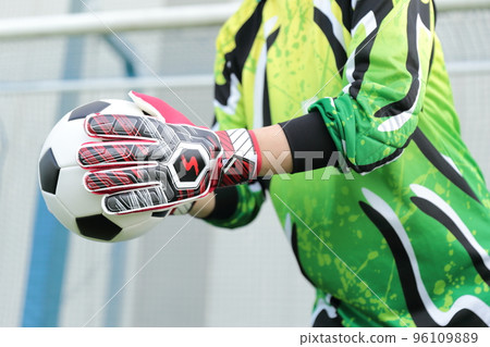 Goalkeeper man catching a soccer ball Goalkeeper man catching a soccer ball 96109889