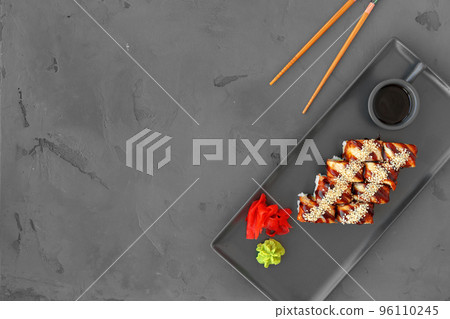 Dragon sushi roll with eel on gray background Dragon sushi roll with eel on gray background 96110245