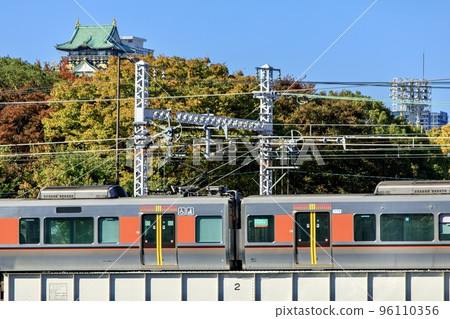 JR West Osaka Loop Line 323 series train running with Osaka Castle in the background JR West Osaka Loop Line 323 series train running with Osaka Castle in the background 96110356