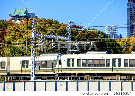JR West Osaka Loop Line 221 series train running with Osaka Castle in the background JR West Osaka Loop Line 221 series train running with Osaka Castle in the background 96110394