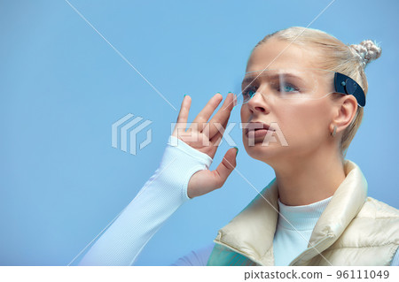Smart glasses and augmented reality concept. Woman wearing modern spectacles with futuristic screen. Virtual technology. Close up of eye surrounded by business statistics and analytics. Future vision. Smart glasses and augmented reality concept. Woman wearing modern spectacles with futuristic screen. Virtual technology. Close up of eye surrounded by business statistics and analytics. Future vision. 96111049