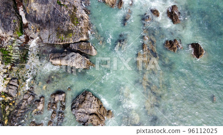 A lot of boulders in the sea. Coastal cliffs of the North Atlantic. Seaside beautiful nature. Dramatic seascape of the north of Europe. Drone point of view. View from above. 96112025