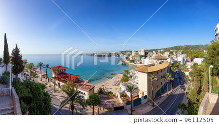 Sandy Beach, Colorful Blue Sea Water and Residential Homes on Coast. Palma, Balearic Islands, Spain Sandy Beach, Colorful Blue Sea Water and Residential Homes on Coast. Palma, Balearic Islands, Spain 96112505