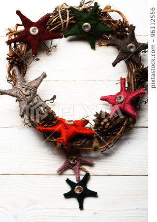 Christmas decor concept. Wreath made of branches with fabric stars 96112556
