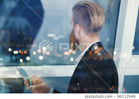 Businessman looks far for the future into the night. Concept of innovation and startup Businessman looks far for the future into the night. Concept of innovation and startup 96112646
