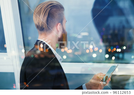 Businessman looks far for the future into the night. Concept of innovation and startup Businessman looks far for the future into the night. Concept of innovation and startup 96112653