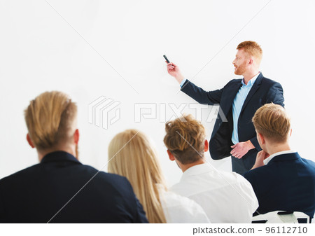 Businessman in office explain something at a training meeting Businessman in office explain something at a training meeting 96112710