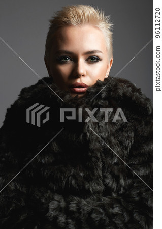 young short blond hair woman in fur. beautiful girl young short blond hair woman in fur. beautiful girl 96112720