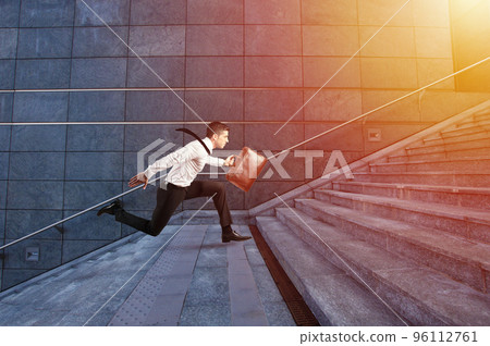 Businessman runs fast over a modern staircase 96112761