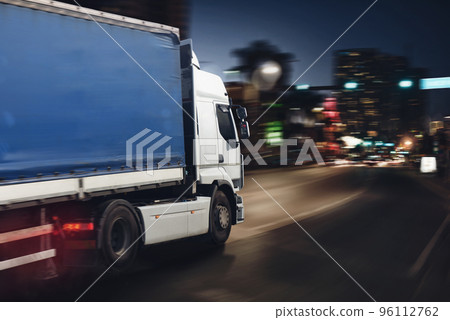 Fast truck on a city road delivering at night Fast truck on a city road delivering at night 96112762