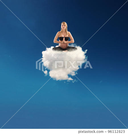 Pregnant woman doing yoga on a cloud 96112823