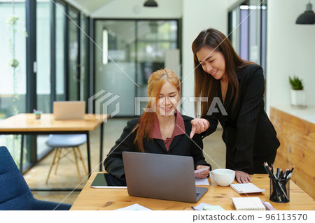 Portrait of an Asian businesswoman consulting, start up a marketing plan to meet the needs of customers in office room 96113570