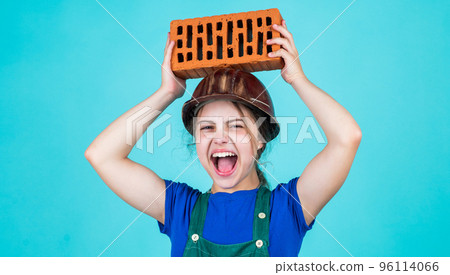kid wear protective helmet. protect head on construction site. teen girl hold brick. little builder with brick. child is engineer architect. building her future house. happy childhood kid wear protective helmet. protect head on construction site. teen girl hold brick. little builder with brick. child is engineer architect. building her future house. happy childhood 96114066