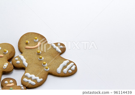 gingerbread man cookies decorated with icing sugar on white background. Christmas food, pastry background. New Year theme. Merry Christmas and Happy New Year Holidays greeting card, frame, banner 96114439