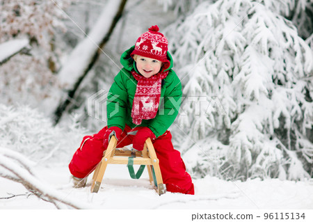 Boy on sleigh ride. Child sledding. Kid with sledge Boy on sleigh ride. Child sledding. Kid with sledge 96115134