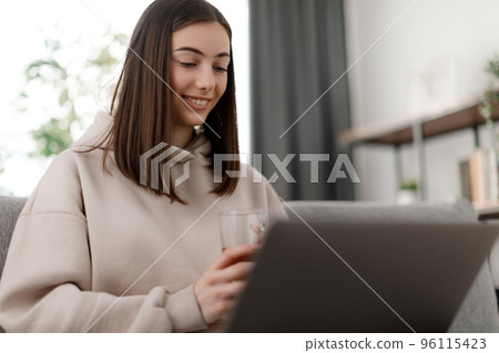 Woman with laptop studying 96115423