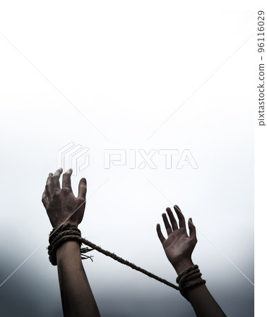 Tied hands raised to the sky 96116029