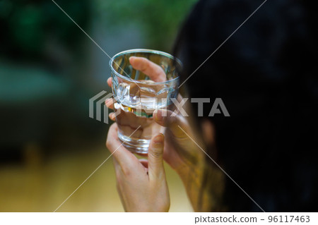Young woman drinking water Young woman drinking water 96117463
