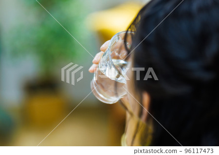 Young woman drinking water Young woman drinking water 96117473