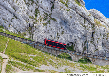 Cogwheel train climbing to the top of Mount Pilatus in Canton Lucerne, Switzerland. World's steepest cogwheel railway 96118372