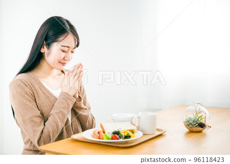 Japanese woman eating rice at home (Itadakimasu) 96118423