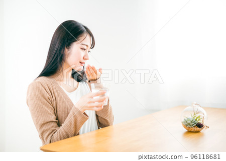 Japanese woman taking medicine and prescription for illness Japanese woman taking medicine and prescription for illness 96118681