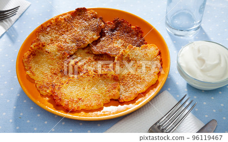 Belarusian potato pancakes draniki with sour cream at plate 96119467