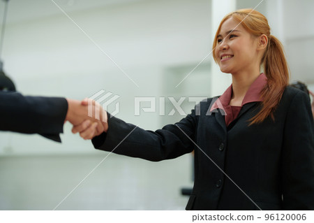 business merger, Asian businesswoman shake hands at the conference room with showcase their collaboration to strengthen their marketing efforts 96120006