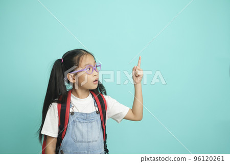 Close-up kid schoolgirl Pointing Fingers At Copy Space. 96120261
