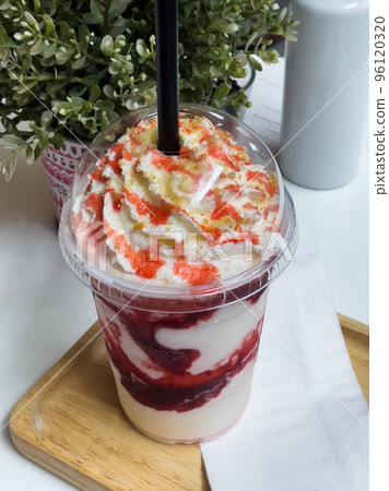 strawberry frappe with whipped cream on table 96120320