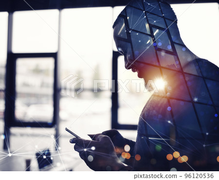 Businessman works with his smartphone in office. double exposure Businessman works with his smartphone in office. double exposure 96120536