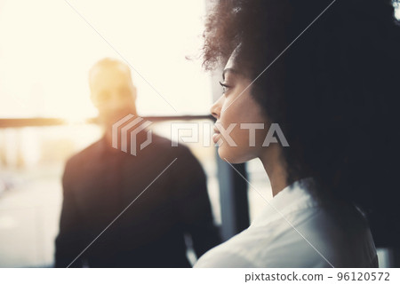 Businesswoman at the office looks through the window for the future 96120572