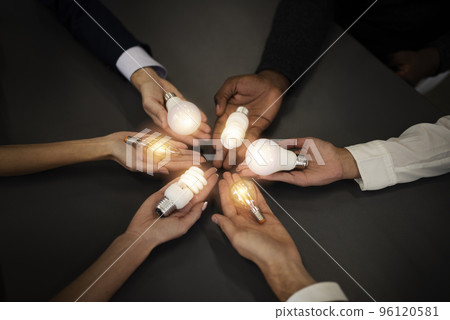 Teamwork and brainstorming concept with businessmen that share an idea with a lamp. Concept of startup 96120581