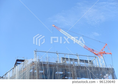 Tower cranes on a large construction site and clear blue sky 96120640