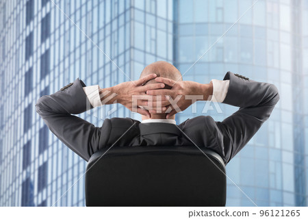 Businessman that relaxes in office and think about the future Businessman that relaxes in office and think about the future 96121265