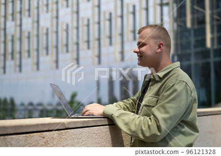 Caucasian man communicates in sign language via video link on laptop.  96121328