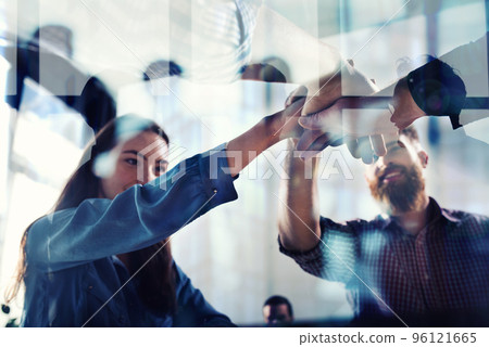 Handshaking business person in office. concept of teamwork and partnership. double exposure with light effects Handshaking business person in office. concept of teamwork and partnership. double exposure with light effects 96121665