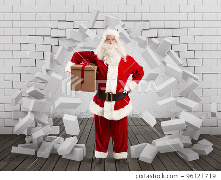 Santa Claus enters to deliver the gift by making a hole in the wall 96121719