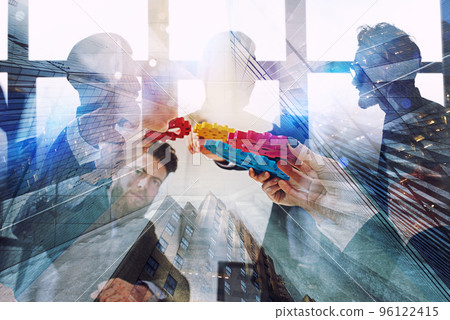 Working group of businessmen find the agreement by holding a piece of gear in hand. concept of teamwork and business partnership. double exposure Working group of businessmen find the agreement by holding a piece of gear in hand. concept of teamwork and business partnership. double exposure 96122415