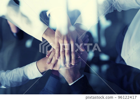 Business people putting their hands together. Concept of startup, integration, teamwork and partnership. Double exposure 96122417