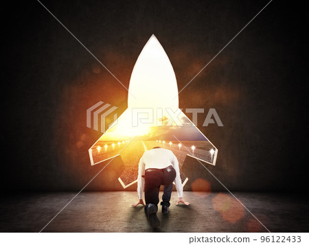 Concept of startup with a rocket shape hole in the wall which alludes to the departure towards new goals Concept of startup with a rocket shape hole in the wall which alludes to the departure towards new goals 96122433