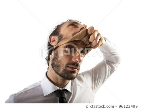 Businessman that removes the mask. Concept of falsity Businessman that removes the mask. Concept of falsity 96122499